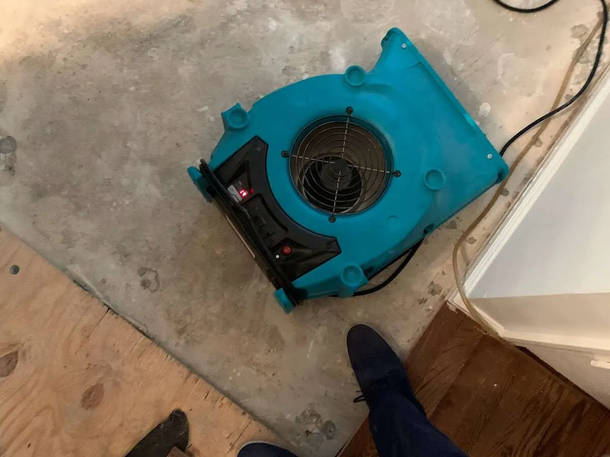 Air mover drying subfloor during Commercial Water Damage Restoration in Johns Creek